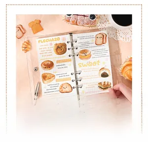 Close-up of decorative bread and pastry stickers on a transparent planner page