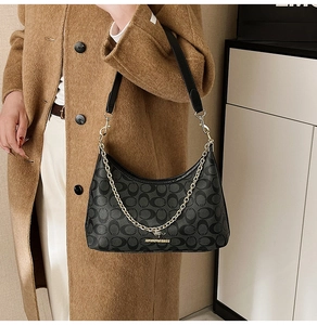 Détail du sac hobo noir avec texture jacquard à motifs C et chaîne dorée élégante