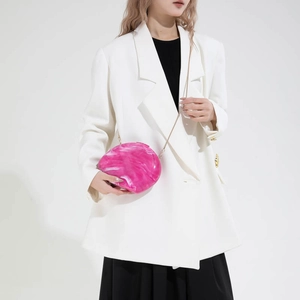 Fuchsia marble acrylic evening clutch bag with metal chain strap on model