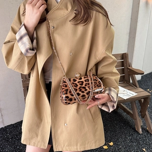 Chic leopard print box clutch bag with pearl clasp and gold chain strap on street backdrop