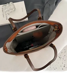 Interior view of brown pebble leather tote showing spacious compartments and storage capacity