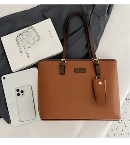 Detailed view of brown lychee texture tote bag with detachable coin purse and shoulder strap