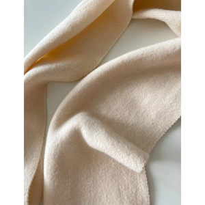 Macro shot of soft knit texture and premium fabric of the thick cream wool scarf