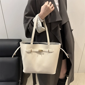 Minimalist beige faux leather tote bag with gold lock and drawstring for commute