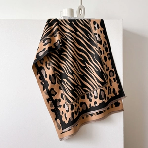 Thick leopard and zebra print shawl in beige and black with subtle gold metallic accents