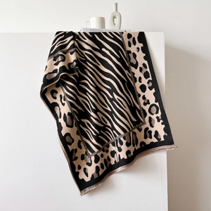 Close-up of leopard and zebra print thick shawl showing soft texture and fringed edges