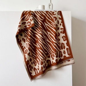 Close-up of animal print scarf showing zebra and leopard patterns with fringe edges
