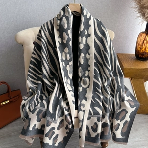Detail of animal print shawl featuring leopard and zebra patterns with soft fringe edges