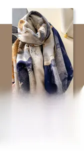 Close-up of soft faux cashmere scarf featuring blue and yellow abstract art pattern