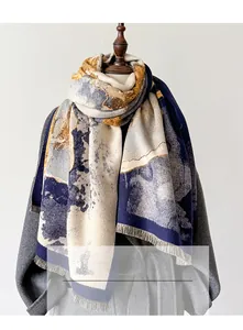 Detail of jacquard knit shawl showing elegant tassel edges and blue floral texture