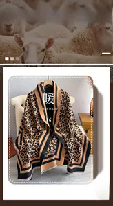 Detail of leopard print scarf featuring warm caramel tones and fine fringe tassels