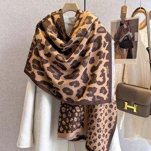 Classic leopard print pashmina shawl with fringe tassels over white winter coat