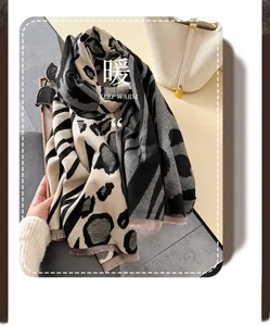 Detail of leopard print scarf showing fine weaving texture and soft fringe tassels