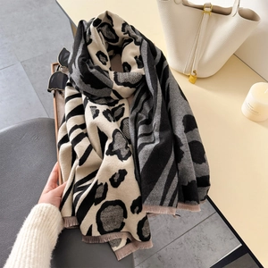 Detail of animal print scarf with leopard and zebra patterns and fringe edges