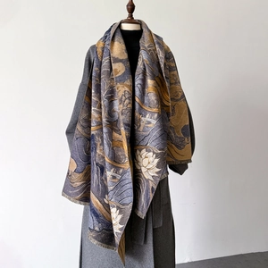 Close-up of floral jacquard cashmere scarf with thick texture and fringe trim