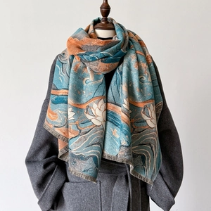 Detail of vintage lotus jacquard scarf with soft tassels in blue and orange hues