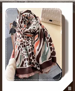 Close-up of leopard pattern scarf showing dense knit texture and fringe details