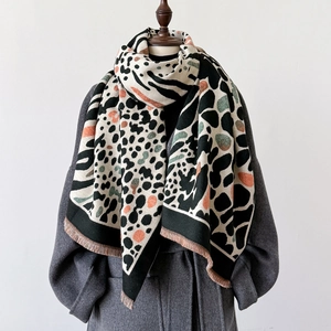 Winter leopard and zebra print shawl scarf with tassels on a dark grey wool coat