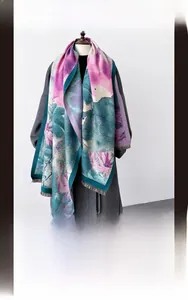 Detail of artistic floral print scarf with soft cashmere texture and fringe tassels