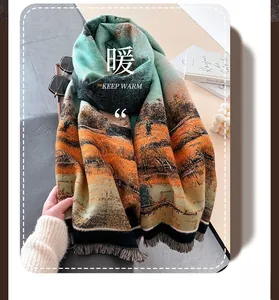 Detailed view of the soft fringed scarf with artistic oil painting pattern in teal and orange