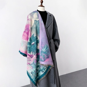 Thick winter artistic floral scarf with tassels shown on a grey coat for women