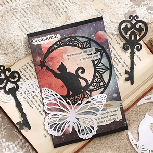 Vintage σετ scrapbooking με πεταλούδες, κάρτα γάτας και κλειδιά σε παλιό βιβλίο
