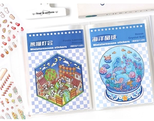 Macro shot of large capacity sticker album with panda lantern and ocean crystal ball themes
