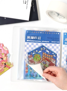 Macro shot of Panda Lantern theme stickers inside a clear PVC storage binder for journaling