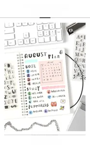 Detailed application of transparent alphabet and number stamps on a daily planner page