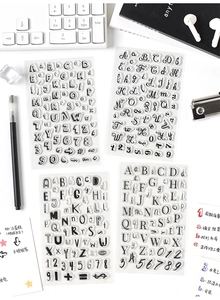 Macro shot of 4 clear alphabet and number stamp sheets for DIY journaling decor