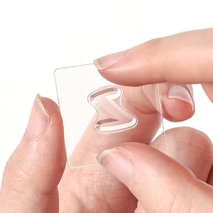 Clear acrylic square stamp block with S-shaped center hole for DIY crafting