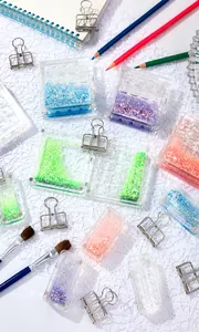 Close-up of portable acrylic watercolor palettes with glitter sand design and magnetic closure