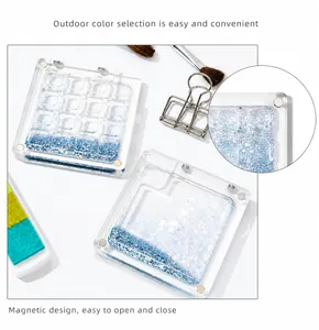 Detail of 16-grid acrylic palette showing magnetic closure and blue glitter base
