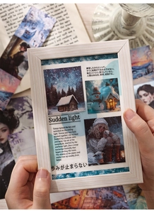 Close-up of vintage white wooden frame with winter theme illustration cards and stickers