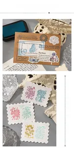 Macro shot of retro floral and butterfly ink stamps on vintage book paper background