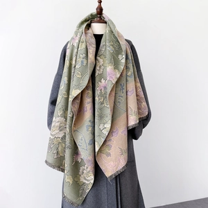 Detail of floral printed shawl with short tassels on a premium wool coat