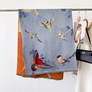 Elegant bird pattern jacquard scarf in grey-blue and orange with soft fringe detailing