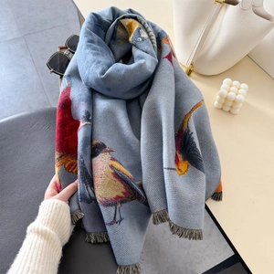 Blue winter scarf featuring colorful bird prints and soft fringe edges for women