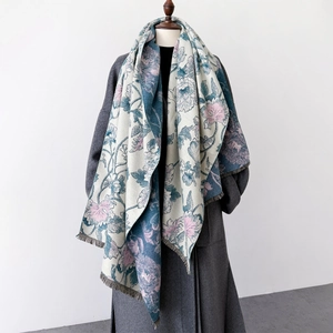 Retro floral print shawl with fringe tassels draped over a coat for winter warmth