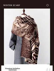 Detail of selected imitation cashmere leopard print winter scarf with soft fringes