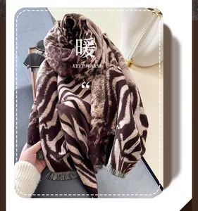 Close-up of thick leopard pattern scarf showing soft texture and fine fringe details