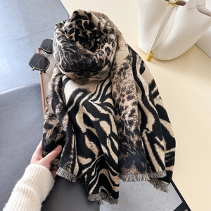 Detail of leopard and zebra print scarf with fringed edges and soft thick texture