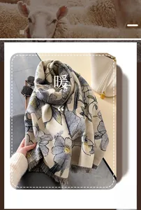 Detailed close-up of jacquard floral pattern and fine fringes on a warm thick scarf