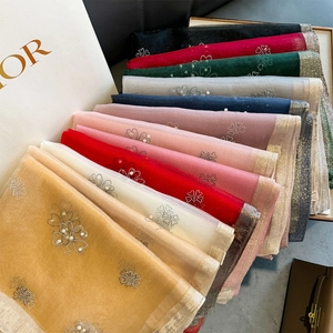 Detail of floral beaded scarves with sparkling gold trim and sheer organza texture