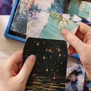 Vintage stationery gift set featuring celestial envelopes and floral list cards in hand