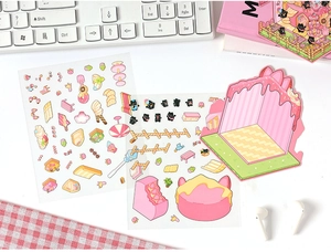 Macro detail of cute 3D cartoon stickers featuring pink dessert and black cat motifs