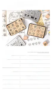 Macro shot of 12-piece Happy Nest wooden bear stamps with vintage storage tin box