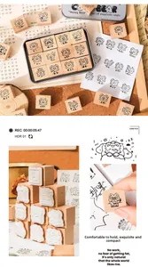 Close-up of 12 cute wooden bear stamps in a silver tin box for DIY scrapbooking