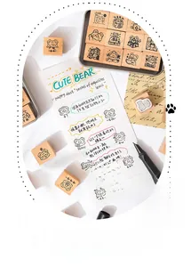 Detailed view of DIY wooden stamp set with cute bear motifs on a paper notebook