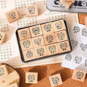12-piece cute animal wooden stamp set with bear illustrations in a grey metal storage box